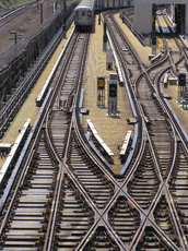 A track crossing from above, with dozens of long track ties under the criss-crossing tracks